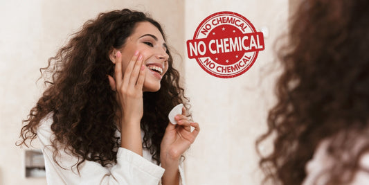Girl applying chemical-free skincare product with label visible
